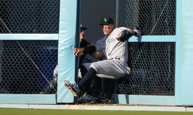 The Yankees’ Aaron Judge runs through the outfield wall to stop another hit